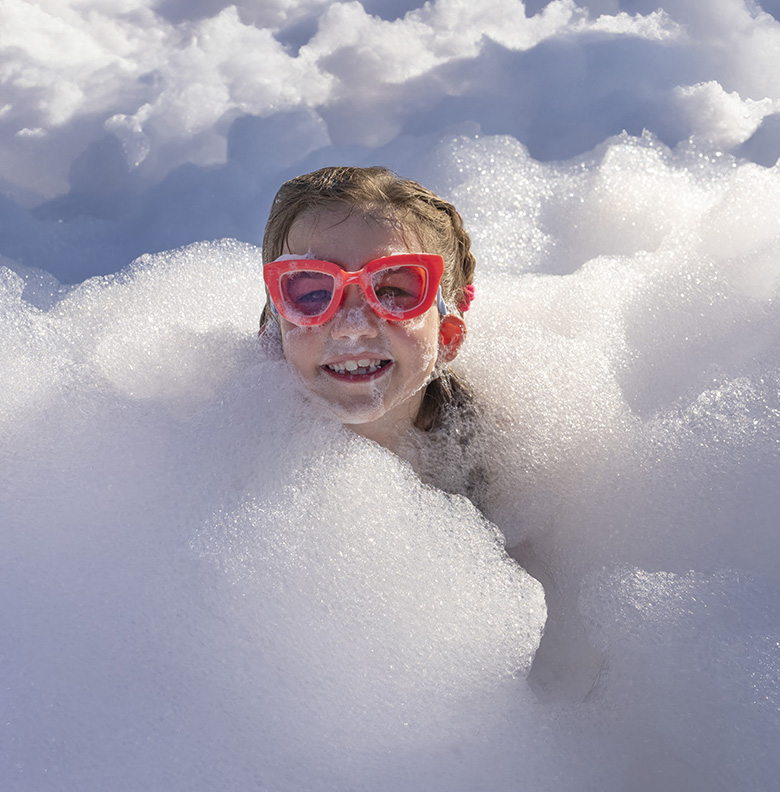 Happy kid enjoying a foam party in Sacramento